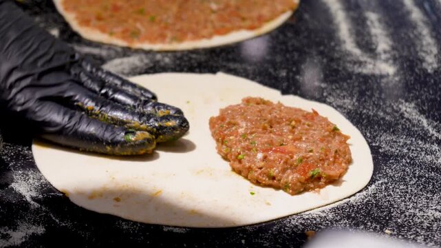 Man Preparing and baking pita kiymal pide and lahmacun. Turkish pizza video