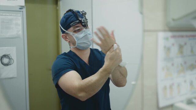 Reflection in mirror hospital clinic doctor man surgeon disinfecting treat palms preparing for plastic surgery laboratory male physician in medical mask uniform washing hands wiping health medication