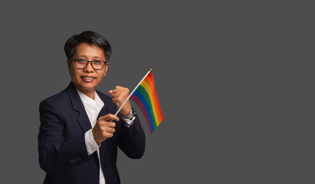 Business woman holding rainbow flag for diversity support