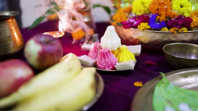 modak sweets and fruits placed for ganesh puja at home temple