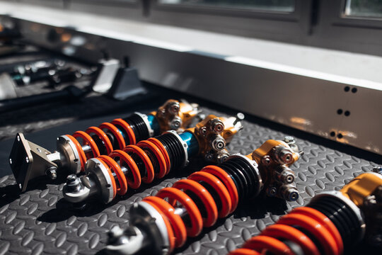Close-up of racing car suspension shock absorber in motorsport garage