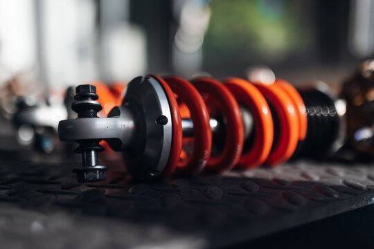 Close-up of racing car suspension shock absorber in motorsport garage