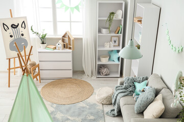 Interior of children's room with tent, sofa and easel © Pixel-Shot
