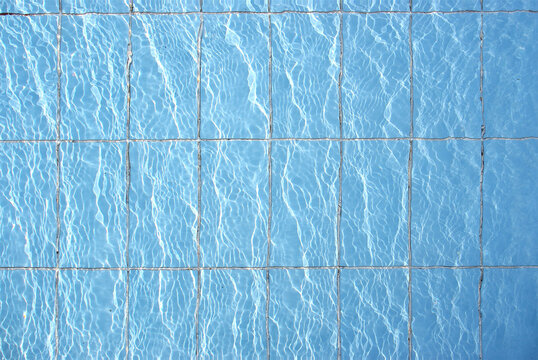 Blue pool filled with water in Summer