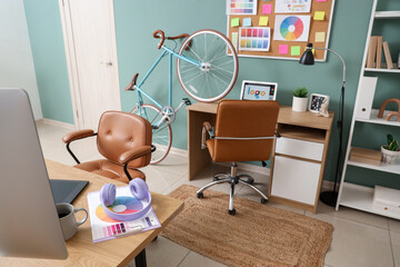 Obraz premium Interior of graphic designer's office with desks and bicycle