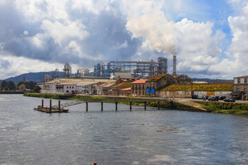 Fototapeta premium Industrial landscape. View of factory on the bank of the Ulla River in Padron, Spain