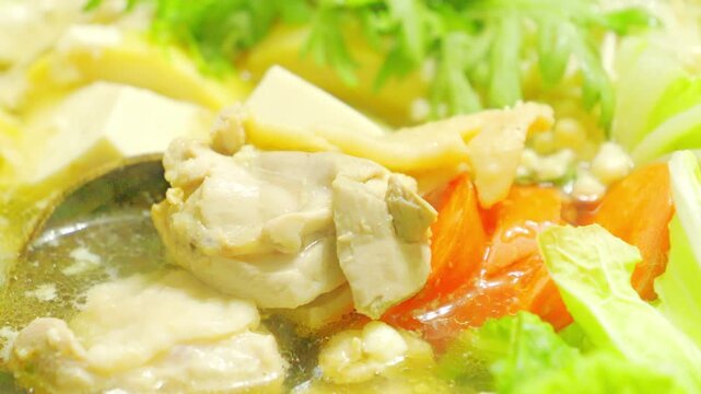 Close-Up Video of Japanese Hot Pot with Chicken, Tofu, and Napa Cabbage