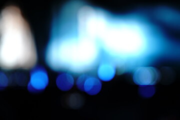 Obraz premium Abstract blue bokeh lights on a dark background, featuring soft defocused circles and cool-toned illumination, ideal for modern, minimal, and atmospheric visual design.