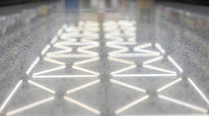 Fototapeta premium modern fluorescent light grid reflection on wet floor minimalist design