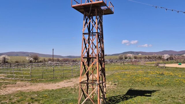 American countryside with vintage and rustic windmill for pumping water on a ranch or farm