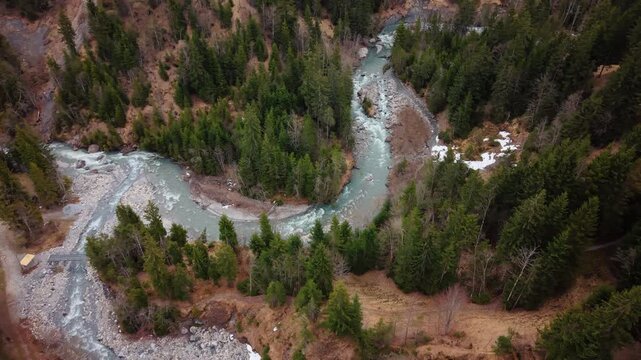 Aerial: orbit drone shot of river near Pochtenkessel deep rock funnel during the day near Adelboden, canton of Bern, Switzerland