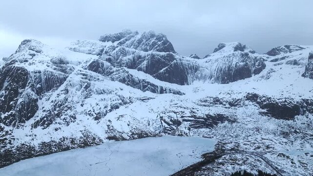 Storvatnet near Nusfjord in Flakstad&oslash;ya Lofoten Norway lies in glacial cirque basin within Precambrian crystalline ridge shaped by Quaternary glaciation as drone orbit parallax reveal