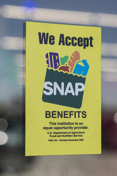 SNAP and EBT Accepted here sign. SNAP and Food Stamps provide benefits to help the budgets of disadvantaged families.