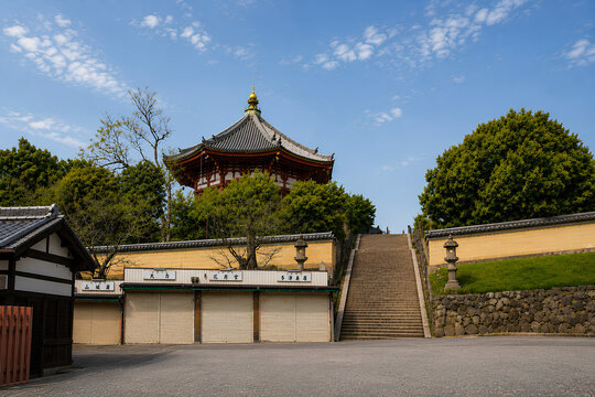 Traditional Japanese Temple and Stone Stairs Under Blue Sky in Nara, Japan