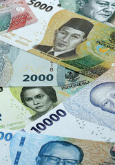 Indonesian rupiah money banknotes pile on table. Indonesia bills of IDR currency close up © Larysa