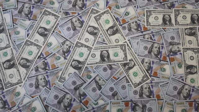 Zoom out from word VAT made of one dollar bills on hundred dollar banknotes