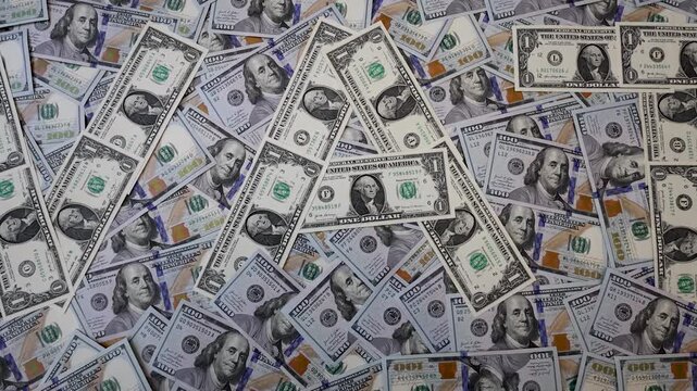 Zoom out from word VAT made of one dollar bills on hundred dollar banknotes