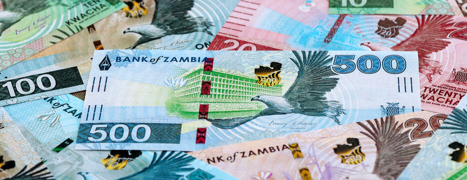 Zambian kwacha money banknotes pile on table. Zambia bills of ZMW currency close up