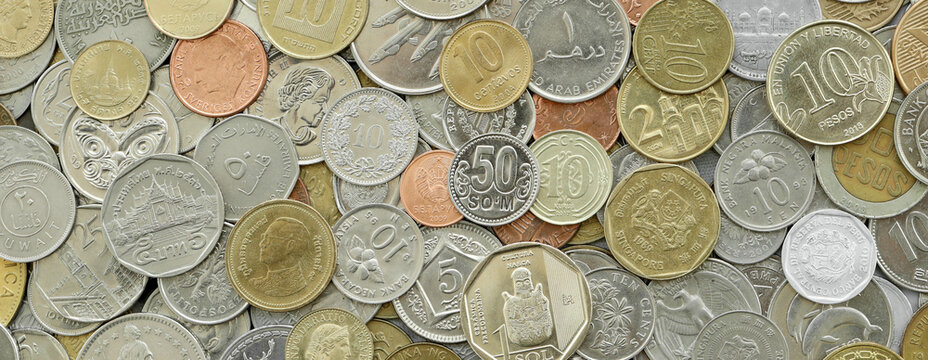 Scattered coins of multiple origins in big mound, detailed shot. World currency variety