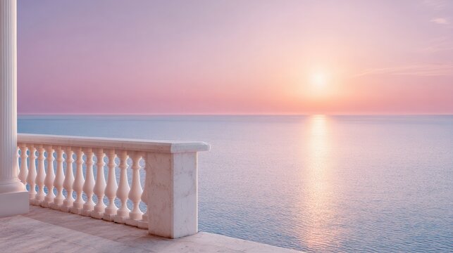 White stone balustrade terrace overlooking calm sea at pastel sunrise with sun reflection