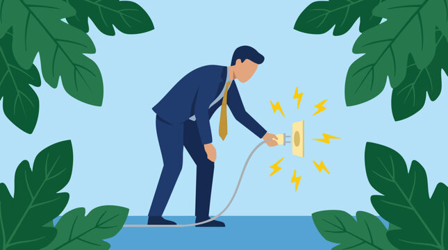 Businessman plugging into electric socket, energy and nature concept