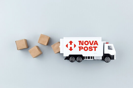 A white toy truck with the NOVA POST logo and boxes on a light background.