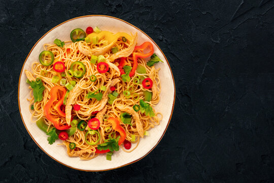 Chow Mein noodles with chicken and vegetables, overhead flat lay shot