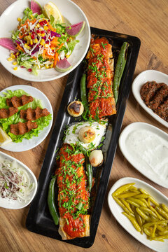 Turkish kebab, beyti sarma, and side dishes.