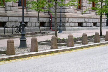 Fototapeta premium Traffic bollards made of stone to prevent cars parking on pedestrian sidewalk. Municipal transportation infrastructure in Oslo, Norway.
