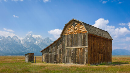 Old, abandoned timber barns and Grand Tetons mountains. Wyoming, USA. © Daniel