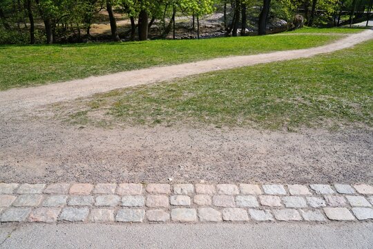 Desire path or desire line. New path created by pedestrian traffic trampling the grass on desired shortcut. Urban planning design problem. Oslo, Norway.