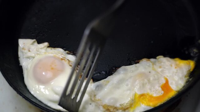 making fried eggs for breakfast