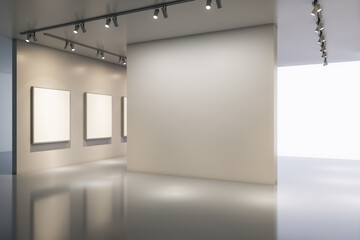 Naklejka premium Minimalist modern gallery interior with large blank wall, empty frames, soft lighting and open exhibition space for artwork display. 3D Rendering