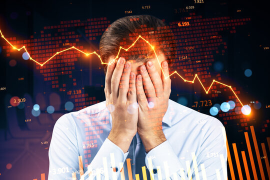 Businessman covering face amid glowing red downward stock chart and global market collapse background illustrating financial crisis impact.