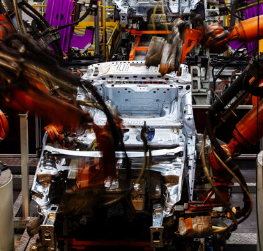 Automated robotic arms are welding on the car body production line.