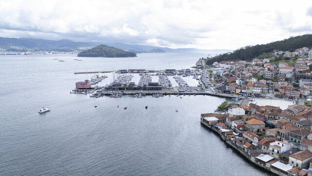 Aerial view of the historic coastal village of Combarro featuring its marina, traditional stone houses, and the Illa de Tambo in the bay Combarro, Pontevedra, Spain.