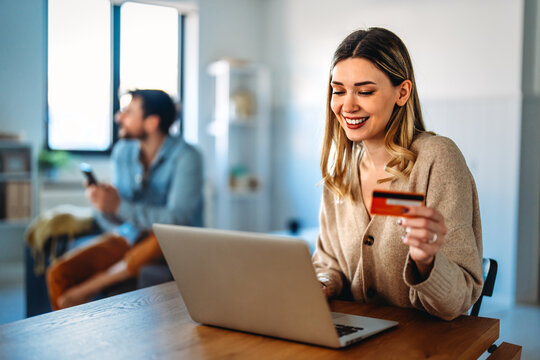 Multicultural couple working remotely, planning finances and investments online. Digital lifestyle