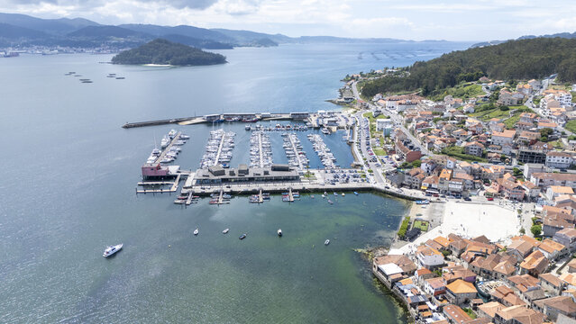 Aerial view of the marina and historic stone houses along the coastline in Combarro, Pontevedra, Spain.