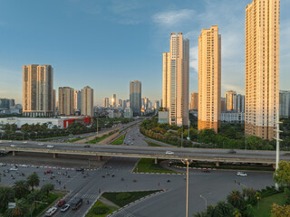 Morning sunlight illuminates high rise residential towers near Thang Long Boulevard with wide roads and modern Hanoi cityscape. © Hanoi Photography