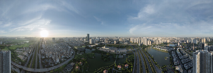 Wide daytime aerial panorama of western Hanoi with lakes, boulevards, dense urban districts, and dramatic cloudy sky. © Hanoi Photography