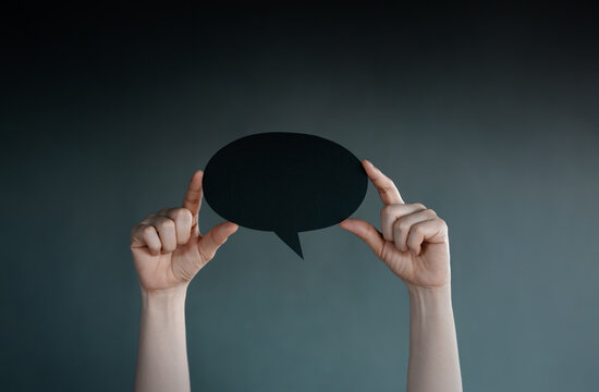 Holding blank speech bubble in dark , Social pressure, emotional expression, mental health