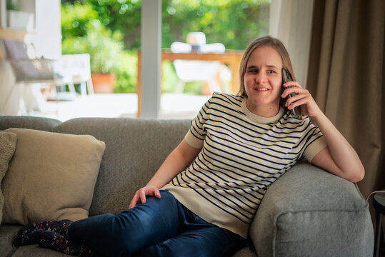 A visually impaired woman using her smartphone at home