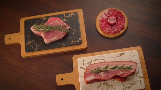 fresh cut raw steak with rosemary on dinner table