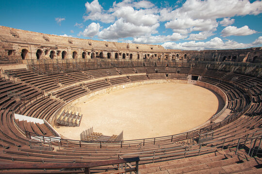Hidden gems of France concept. Inside The Arena of Nimes. One of the best preserved Roman amphitheatre in the world. Interiror outdoor shot. Sunny weather, cloudy sky