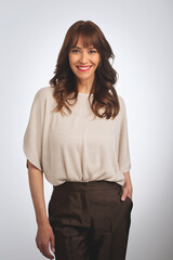 Fototapeta premium Studio shot of a brunette haired woman standing against isolated background wiht copy space