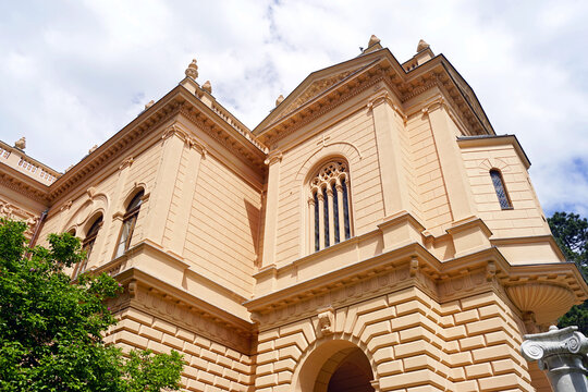 Palace of the Patriarchate facade in Sremski Karlovci rising above greenery. Depicts religious heritage architecture, Habsburg-era urban history, and lesser-known Balkan cultural destinations.