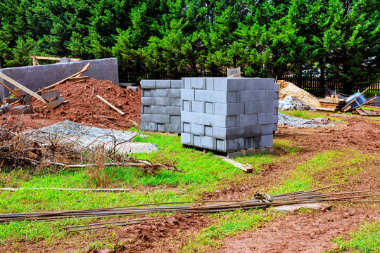 Construction site with building materials cinder blocks gravel path