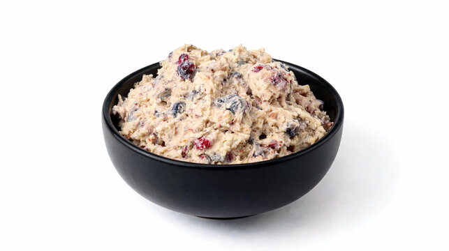 Authentic Alaskan Akutaq Eskimo Ice Cream with Mixed Berries and Tundra Fruit Served in a Black Bowl Isolated on White Background. Traditional Indigenous Arctic Dessert with Reindeer Fat and Berries.