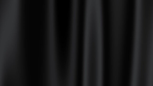 Smooth black curtain gently sways in soft light