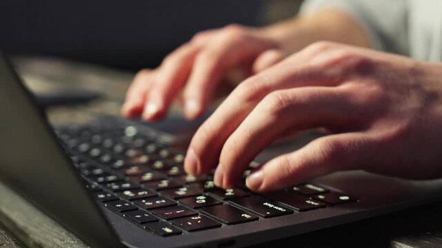 man, hands, typing, keyboard, laptop, macbook, side view, outdoor, wooden table, working, remote work, freelancer, technology, digital, productivity, business, closeup, fingers, natural light, dayligh